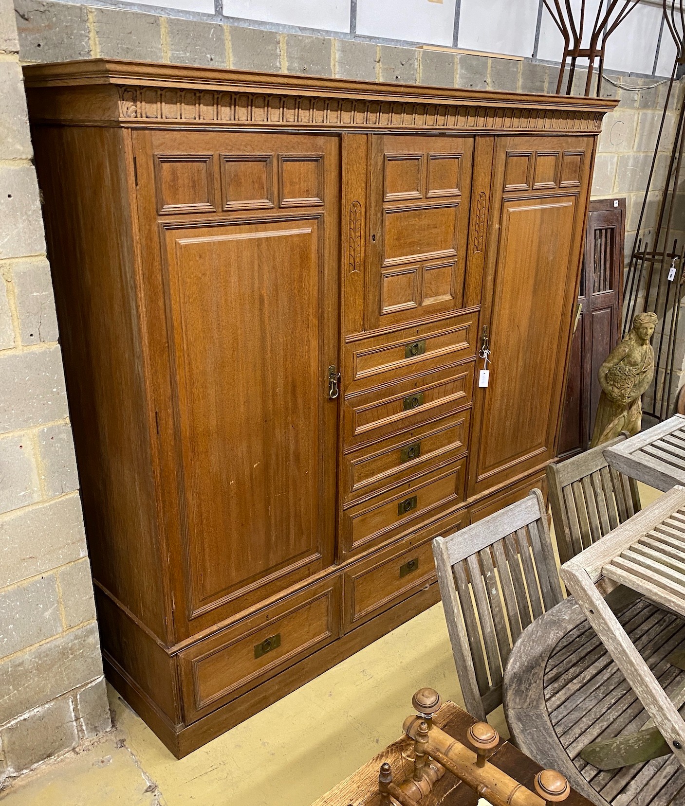 A late 19th century German Art Nouveau oak compactum wardrobe, length 224cm, depth 56cm, height 204cm